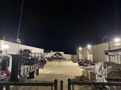 Commercial power equipment dealer site with upgraded exterior LED lighting at night