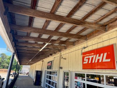 Daytime view of commercial storefront canopy with new exterior lighting installation
