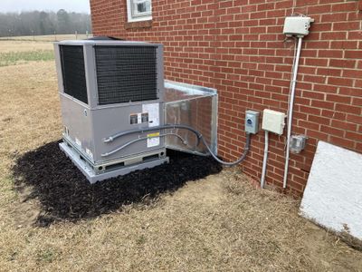 Residential HVAC package unit relocation with new electrical disconnect and conduit