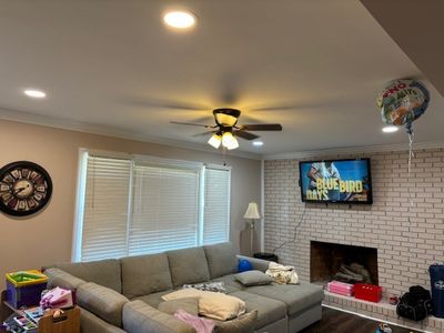 Living room with recessed lighting and ceiling fan installation
