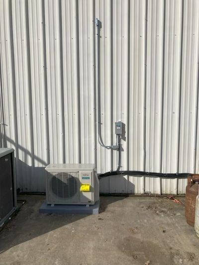 Commercial workshop mini-split heat pump installation with exterior disconnect