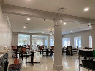 Nursing home dining room with new recessed lighting and pendant fixtures