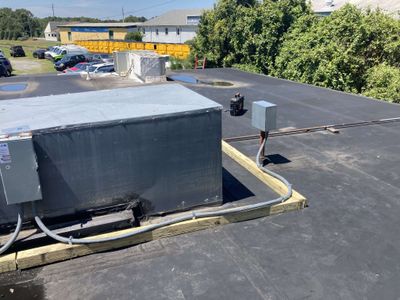 Rooftop commercial HVAC unit electrical retrofit with disconnect and conduit run